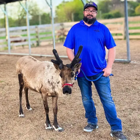 a man standing next to a horse
